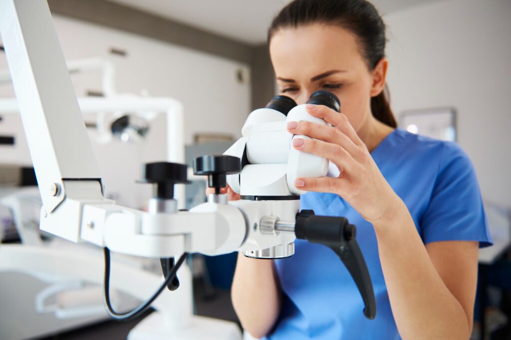 A female orthopedic doctor in Kota examining a sample through a microscope in her laboratory.jpg