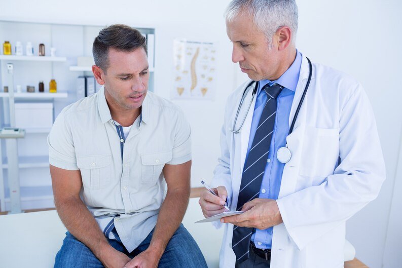 A male doctor consults with a patient at the Orthopedic Hospital in Kota, discussing treatment options.jpeg