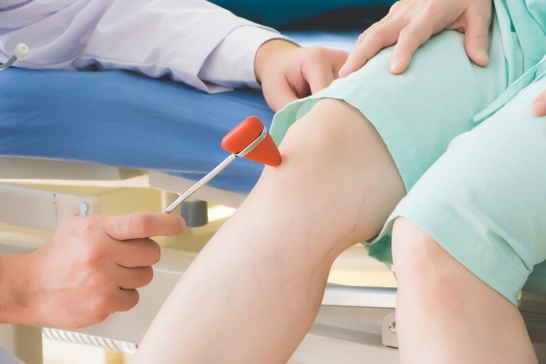 A doctor examines a patient's knee in a clinic, specializing in bone health in Kota.jpeg
