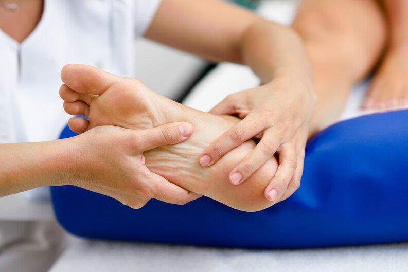 A person receiving a foot massage from an orthopedic doctor in Dadabari, Kota, focusing on relaxation and therapy.jpeg